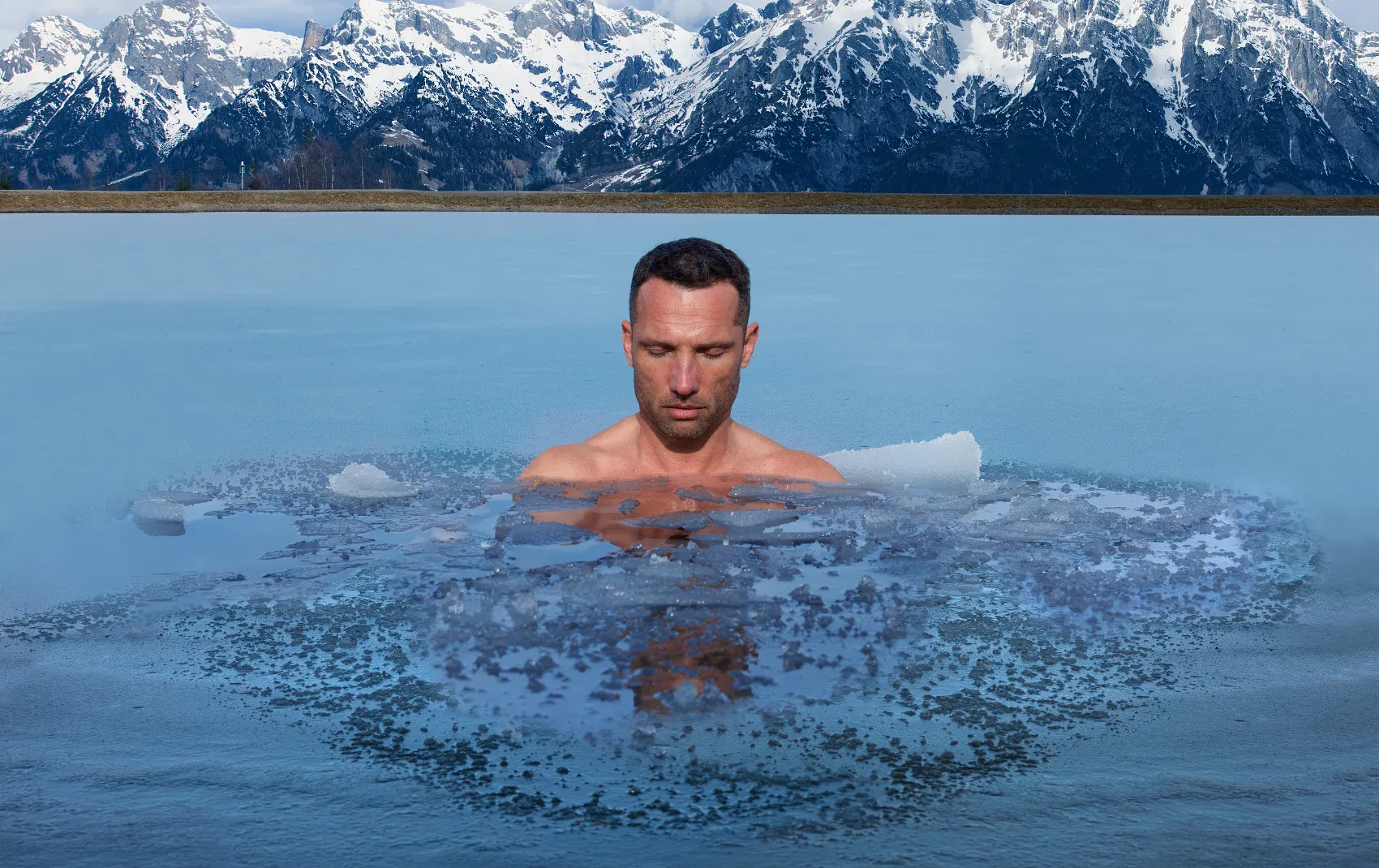 Man standing still in an ice pond