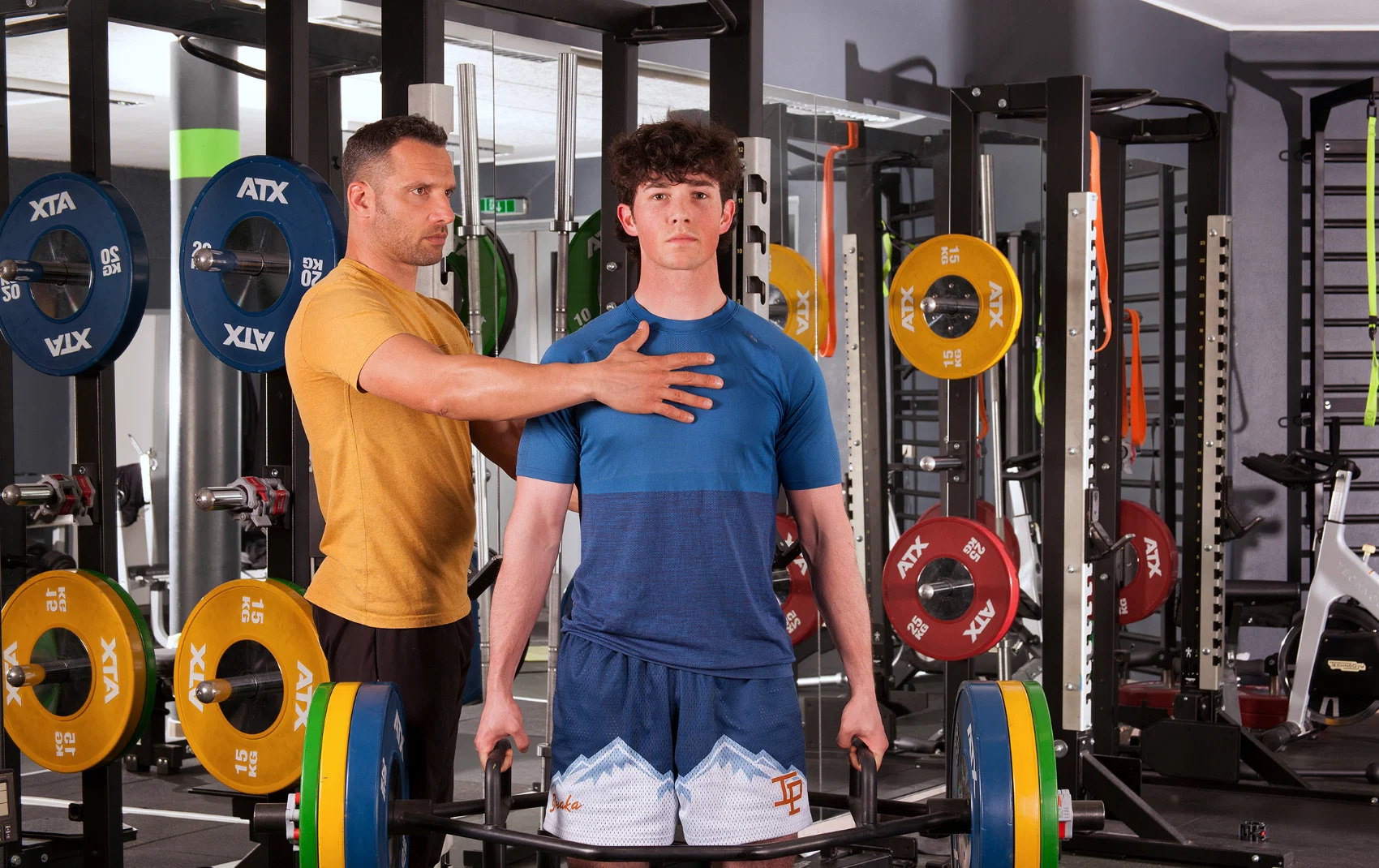 Coach and student in a gym practicing breathing techniques